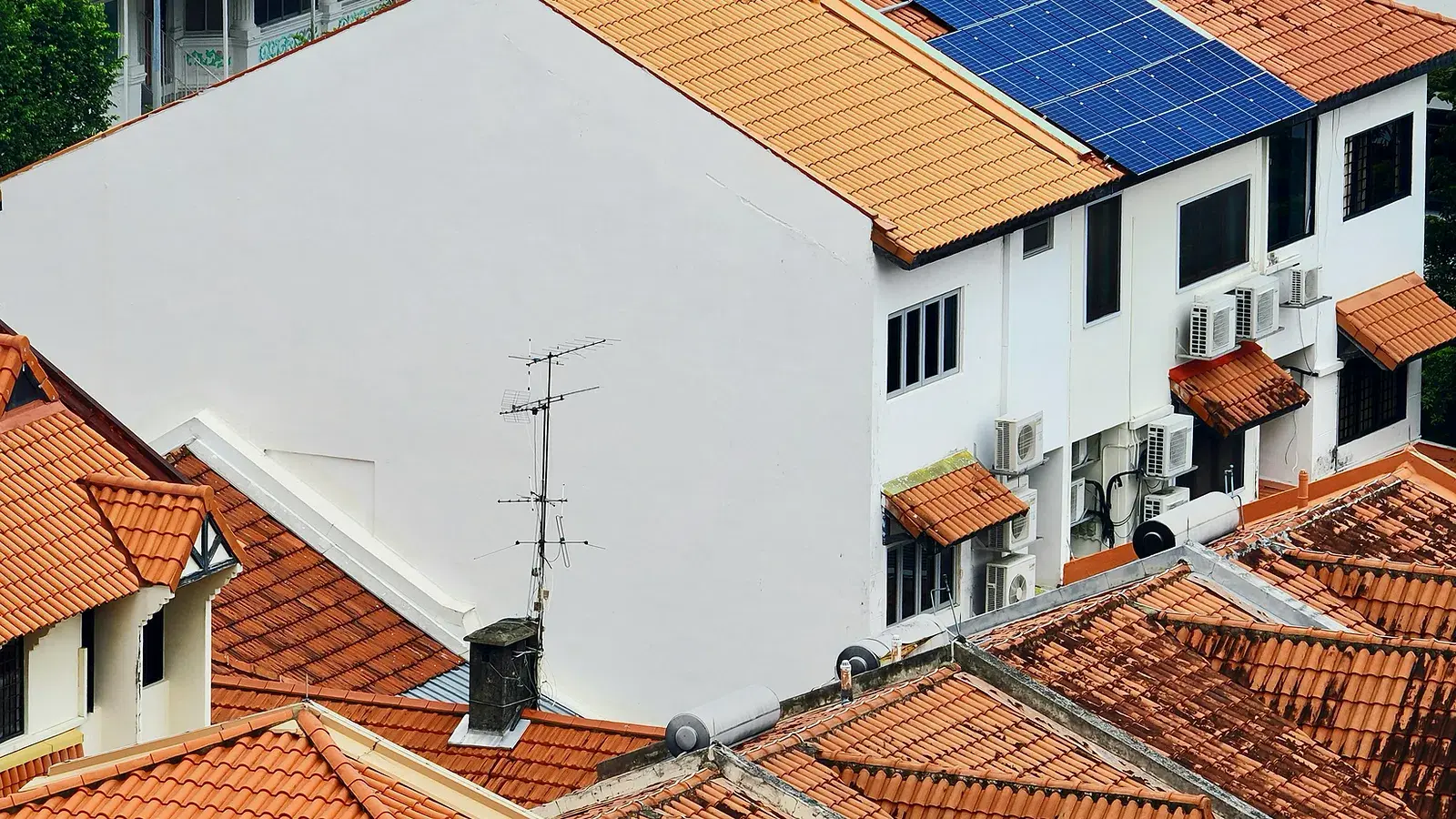 Representative rooftop solar installation on closely spaced tropical homes