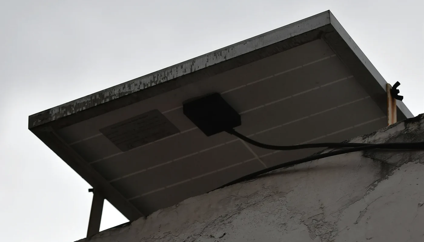 Rooftop solar panels under heavy clouds, emphasizing that panels alone do not provide outage backup