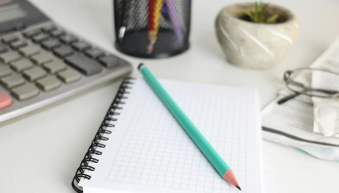 Calculator and notebook used to review solar loan terms and repayment assumptions