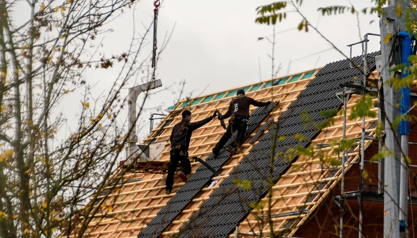 Roofing crew completing installation work that should be defined in a solar quotation