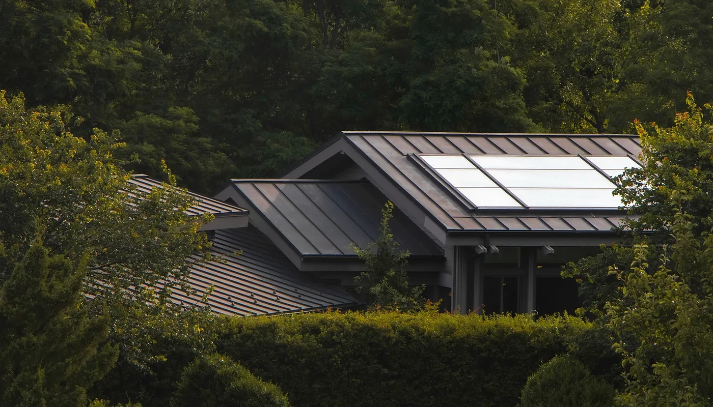 Solar-equipped home surrounded by tall trees that can create roof shading