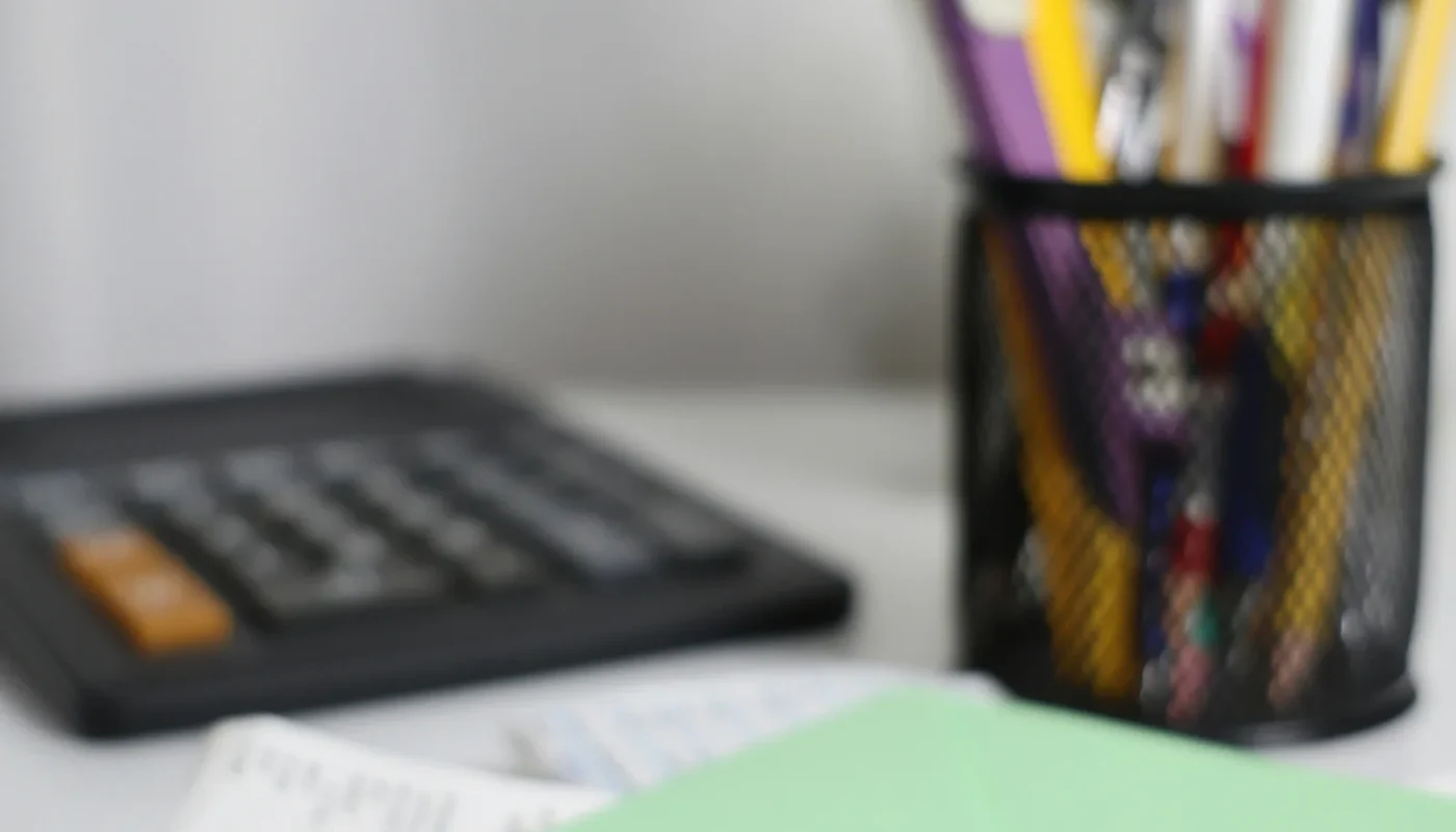 Calculator, envelope, and planning papers for comparing cash and solar financing