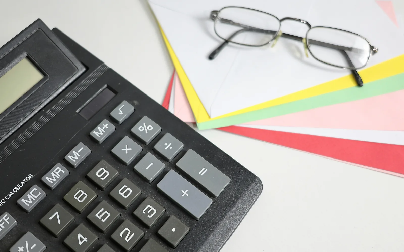 Calculator and planning papers used to evaluate a solar payback period